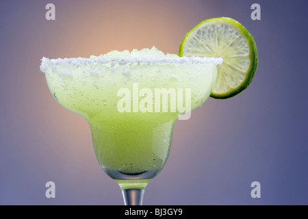 Frozen Margarita with Lime Garnish on Highlighted Background Stock Photo