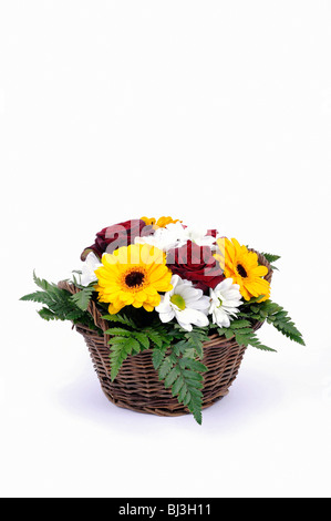 Bouquet of roses, daisies, gerbera, ferns, arranged in a basket Stock Photo