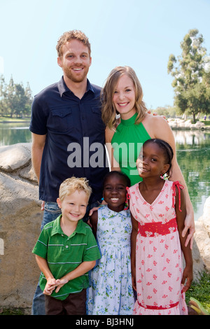 ethnic multi racial racially diverse multicultural multi cultural Young couple with son adoption West African siblings looking at camera MR  © Myrleen Stock Photo