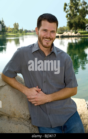 Portrait of 20 to 30 year old young man in park young person people nature, natural surroundings, relaxed relax relaxing MR  © Myrleen Pearson Stock Photo