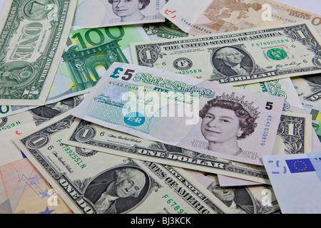 A mixture of bank notes, U.S. dollars, euros and British pounds Stock Photo