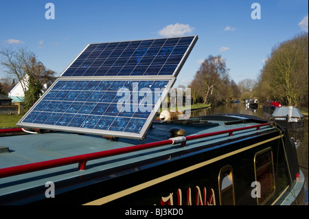 solar panels on the roof of a narrow boat Grand Union canal at Middlesex Uxbridge West London UK Stock Photo