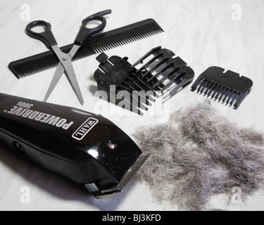 Wahl hair clippers with combs,  scissors and hair clippings. Stock Photo