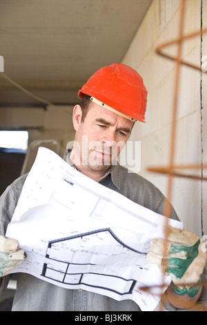 craftsman looking at a blueprint Stock Photo - Alamy