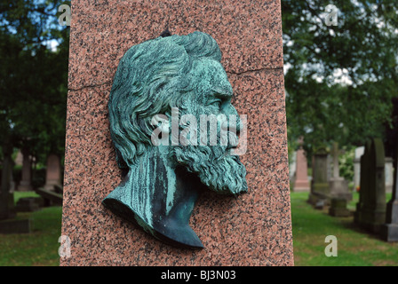 The cameo of a Victorian  gentleman on a pink granite obelisk in the Grange cemetery, Edinburgh. Stock Photo