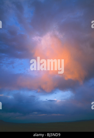 Cumulus clouds illuminated by glowing sunset light, Gallatin Valley, Gallatin County, Montana, USA Stock Photo