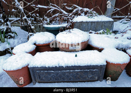 garden pots plants cover covered blanketed blanket of snow garden patio winter scene scenic Stock Photo