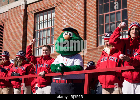 Boston Red Sox mascot, Wally the Green Monster, gestures while dressed in a  medical white coat outside Fenway Park, Monday Feb. 1, 2021, in Boston.  Fenway Park is one of several large