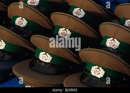 Displayed on a table at the Brandenburg Gate in Berlin, a year after the fall of the Berlin Wall, peaked caps of the DDR. Stock Photo
