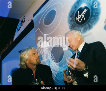 Virgin boss Sir Richard Branson and former Apollo (11) astronaut Buzz Aldrin chat by Virgin Galactic's SpaceShipTwo model. Stock Photo