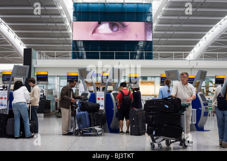 A scene of busy modern air travel as international passengers check-in at the British Airways Heathrow Airport's Terminal 5.