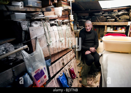 Tattooed hermit Tom Leppard (aka Leopard Man) comfortable in his secret makeshift underground hideaway shelter on Skye, Scotland Stock Photo