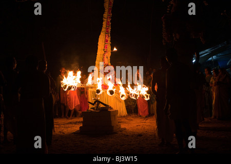 India, Kerala, Cannanore (Kannur), Theyyam, ancient folk art ritual, Agni-Ghandakaran dancing surrounded by flaming torches Stock Photo