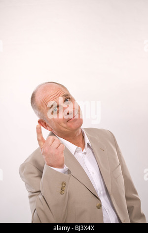 Man pointing his index finger up, laughing Stock Photo