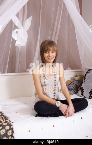 Portrait of a 14 year old girl in her bedroom. Stock Photo