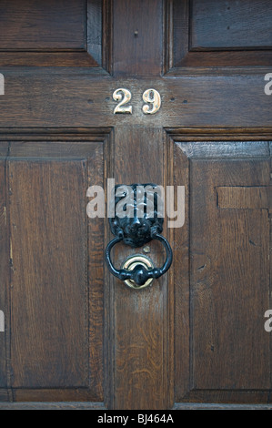 door knocker on wooden door with number 29 on Stock Photo