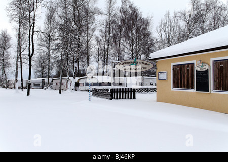 German Beer Garden and Mobile Caravan Homes Covered in Snow at a Camping Ground at the Chiemsee, Chiemgau, Upper Bavaria Germany Stock Photo