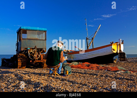 Artist painting fishing boat on the beach at Aldeburgh a fishing town in Suffolk East Anglia England UK Stock Photo