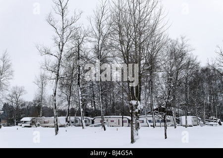 Mobile Caravan Homes Covered in Snow at a Camping Ground at the Chiemsee, Chiemgau, Upper Bavaria Germany Stock Photo