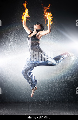 Young woman modern dance. Water studio photo and fire effect. Stock Photo