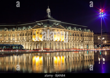 Bordeaux place de la bourse old stock exchange monument with car traffic, streetcar and reflection on water mirror. Stock Photo
