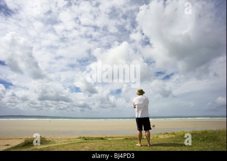 A man on a dune overlooking the sea, Brittany, France, Europe Stock Photo