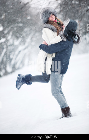 Young couple in a park. Winter season.