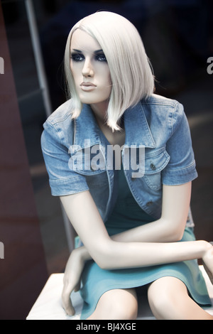 Beautiful mannequin in a shop window. Stock Photo