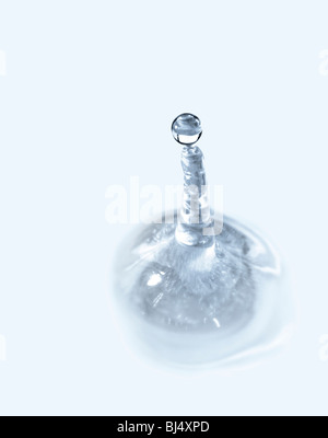 Water splash isolated over light blue background. Macro abstraction Stock Photo