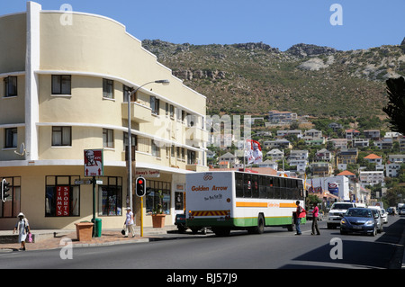 Golden Arrow service bus in Fish Hoek a seaside resort town close to Cape Town South Africa with housing on the mountainside Stock Photo
