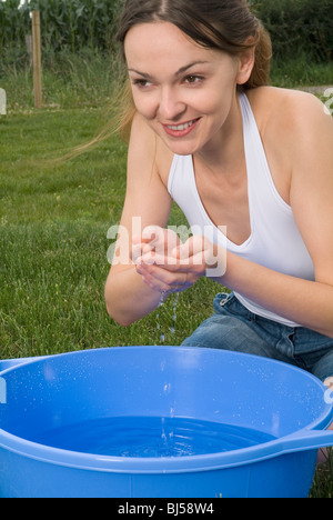 woman, camping, water, face, washing, cleaning, wash, appease, relax, spa Stock Photo