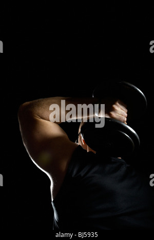 bodybuilder with weight behind head Stock Photo