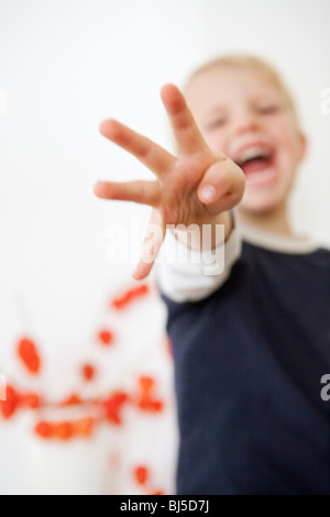 Boy pointing four fingers Stock Photo