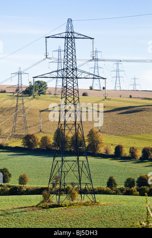 Pylons striding across the Cotswold countryside near Cassey Compton, Gloucestershire Stock Photo