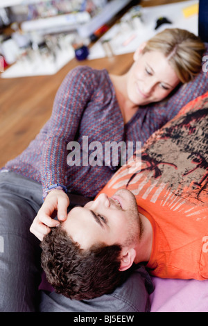 couple lying on couch caressing Stock Photo