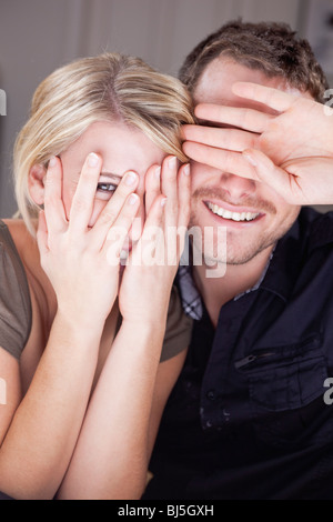 couple hiding behind their hands Stock Photo