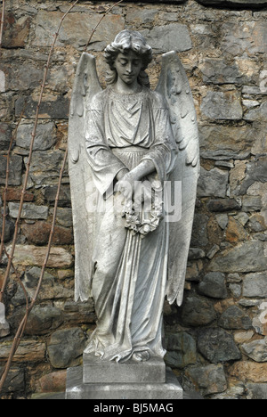 Statue of an angel holding a wreath in the Dean Cemetery Edinburgh, Scotland. Stock Photo