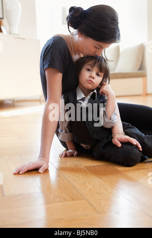 Mom and her Latin American son sitting playing with the cell phone. The