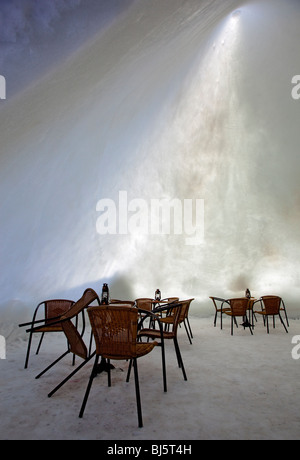 The interior of a snow cafe made of compacted snow and ice in Finland at Winter, sun glowing through thin snow walls , Finland Stock Photo