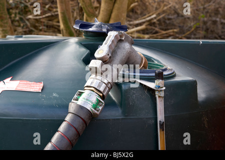 domestic home heating oil tank being refilled with 28 sec kerosene in a garden in northern ireland uk Stock Photo