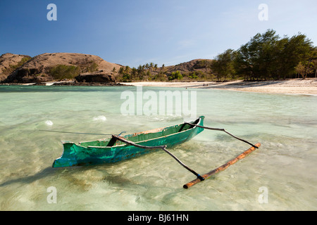 Indonesia, Lombok, Tanjung, beach, fishermens dugout boat in shallow water