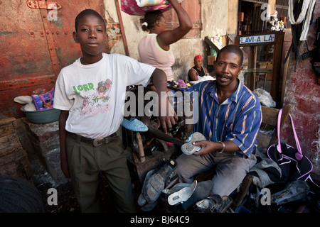 Cobblers at work in the market in central Port au Prince, Haiti Stock Photo