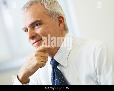 portrait of mature business man with hand on chin, looking away. Copy space Stock Photo