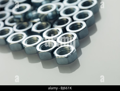 screw bolts on reflective white surface. Stock Photo