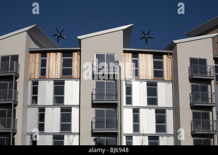 Wind turbines on top of  new build residential flats and apartments Stock Photo