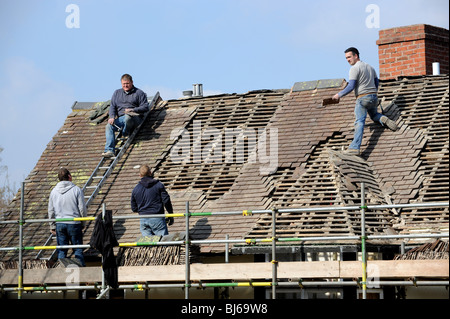 Roof tilers working on old building in Leintwardine Herefordshire England Uk Stock Photo