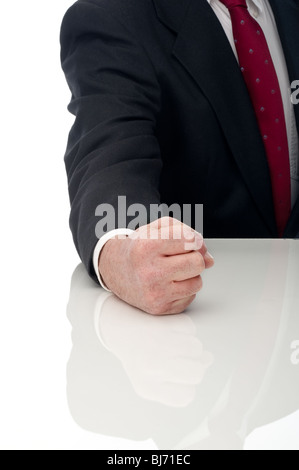 Vertical image of an angry business man banging fist on table Stock Photo