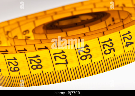 diet - yellow measuring tape isolated on white background Stock Photo ...