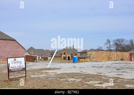 AVAILABLE sign on lot for house to be constructed Stock Photo