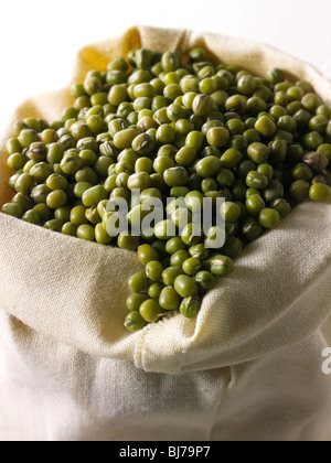 Whole mung beans, or green gram, maash, moong - close up full in a canvas bag (Vigna radiata) Stock Photo